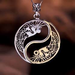 A silver and gold Yin Yang pendant